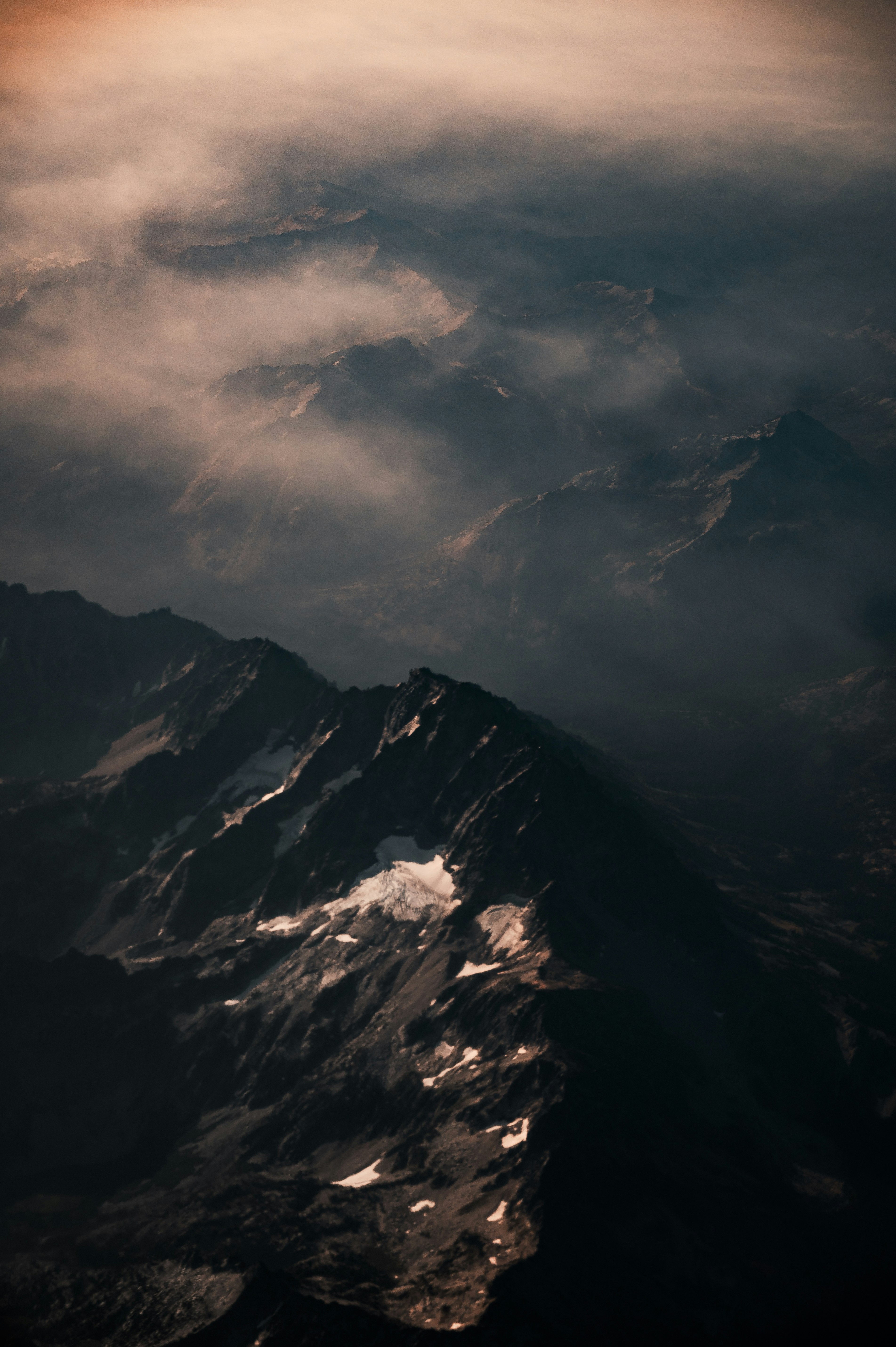 black and white mountain under white clouds